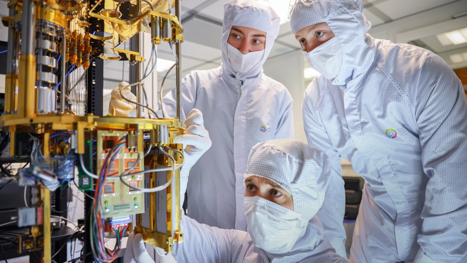 Engineers working on qubit measurement equipment in an international quantum laboratory